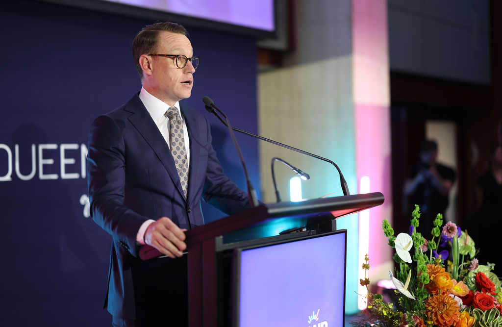 TIQ CEO Justin McGowan speaking from behind a lecturn.
