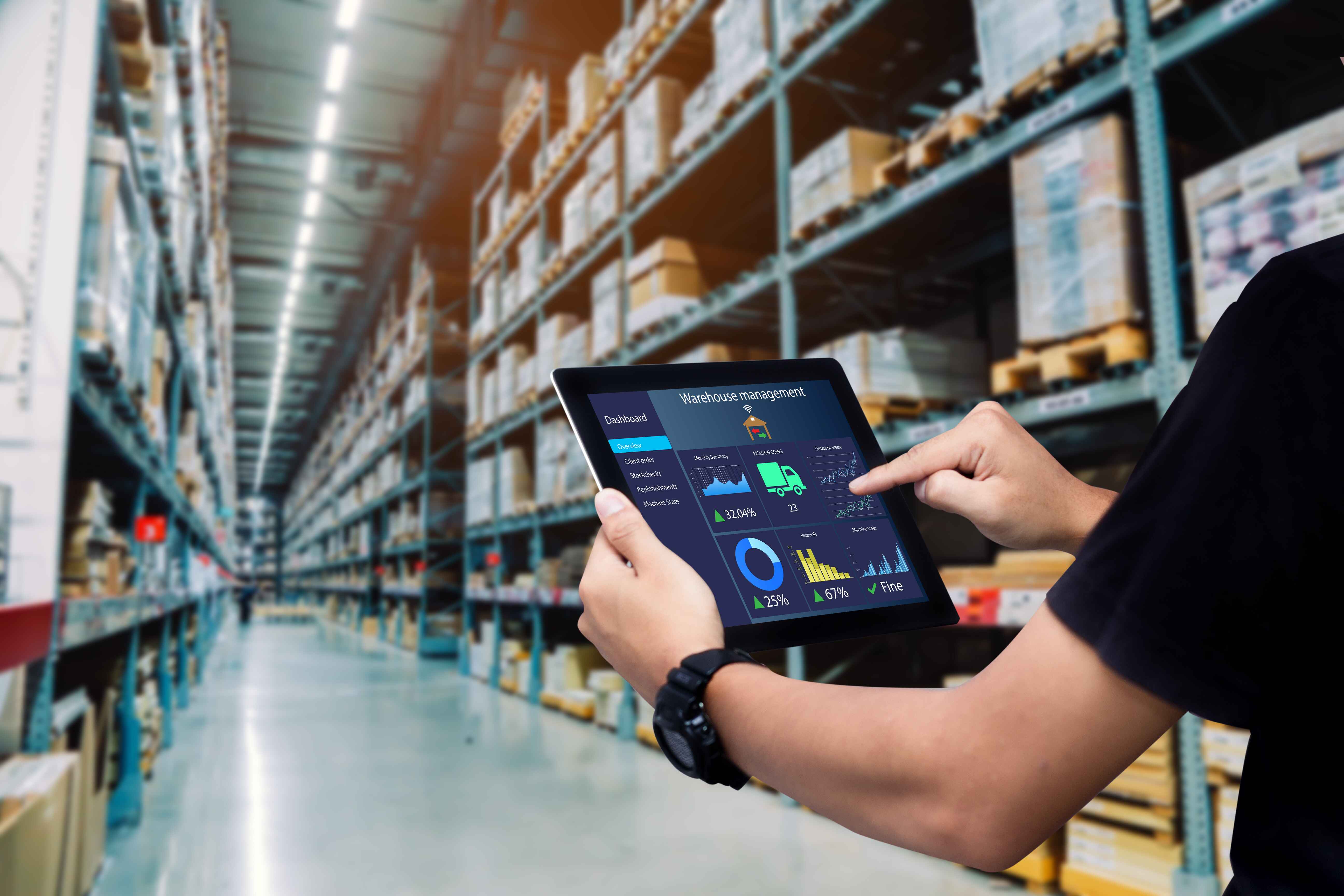 Man on an iPad in warehouse